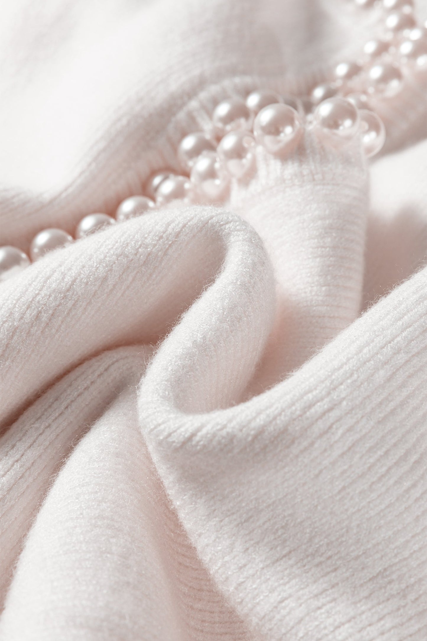 "Women's white pearl embellished cardigan styled — premium knitwear Freedom Fulfillment"